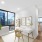 spacious home office with desk set up and close access to living room