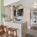 a kitchen area that's connected to the living room and a hallway leading to a stacked washer and dryer